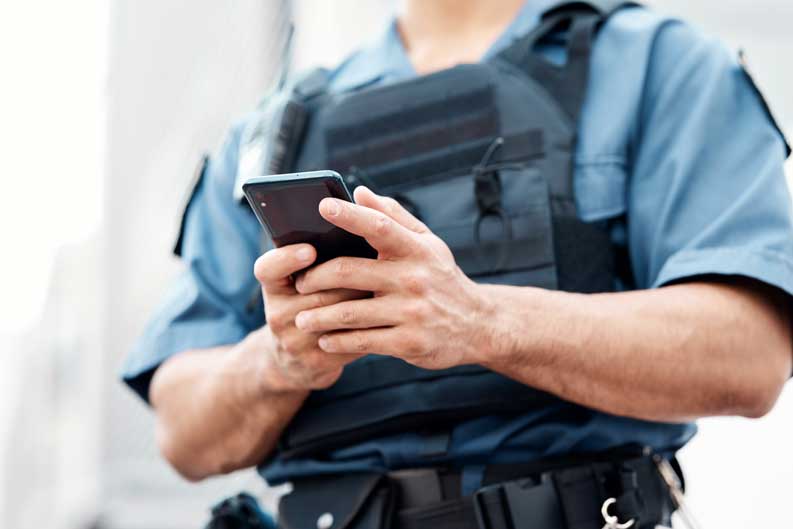 policeman holding cellphone
