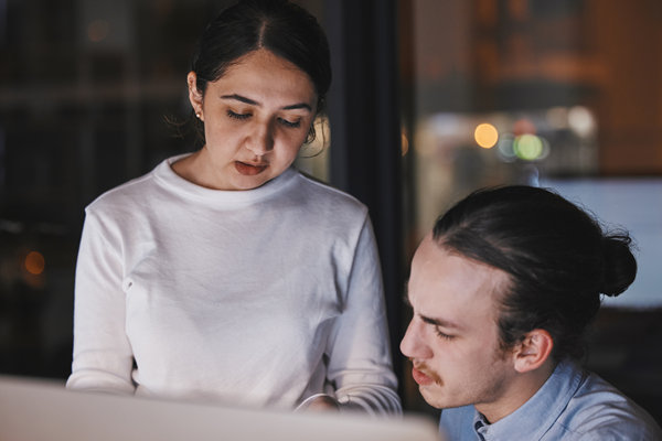 working talking and office team by a computer